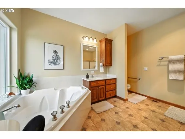 a bathroom with a glass shower door and a mirror