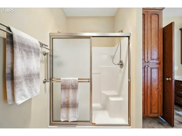 a bathroom with a granite countertop sink a toilet a mirror and shower