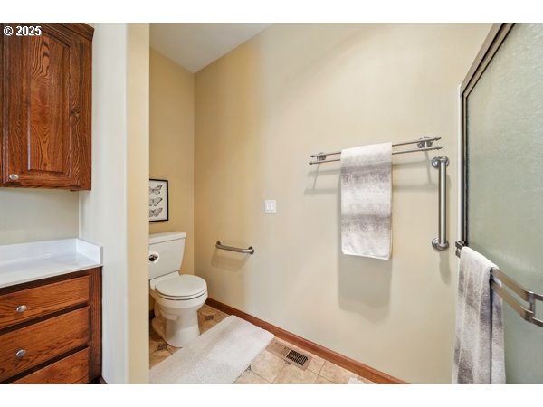 84634 Winesap Road Milton Freewater, OR 97862 - Photo 28 of 46 a bathroom with a granite countertop sink a toilet a mirror and shower