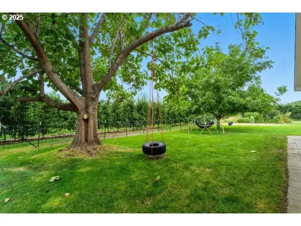 a backyard of a house with table and chairs