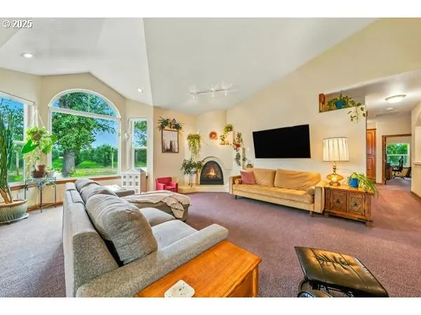 a kitchen with stainless steel appliances kitchen island granite countertop a refrigerator a stove top oven a sink with island and chairs