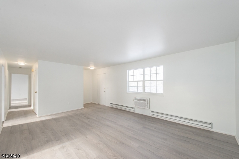 322 Richard Mine Road, Unit F5 Wharton, NJ 07885 - Photo 11 of 22 an empty room with wooden floor and windows