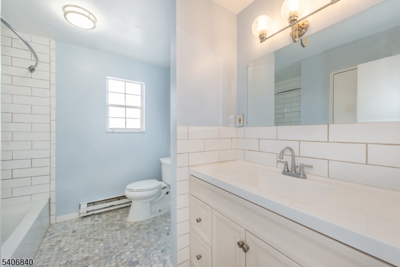 322 Richard Mine Road, Unit F5 Wharton, NJ 07885 - Photo 20 of 22 a bathroom with a sink a toilet and a mirror