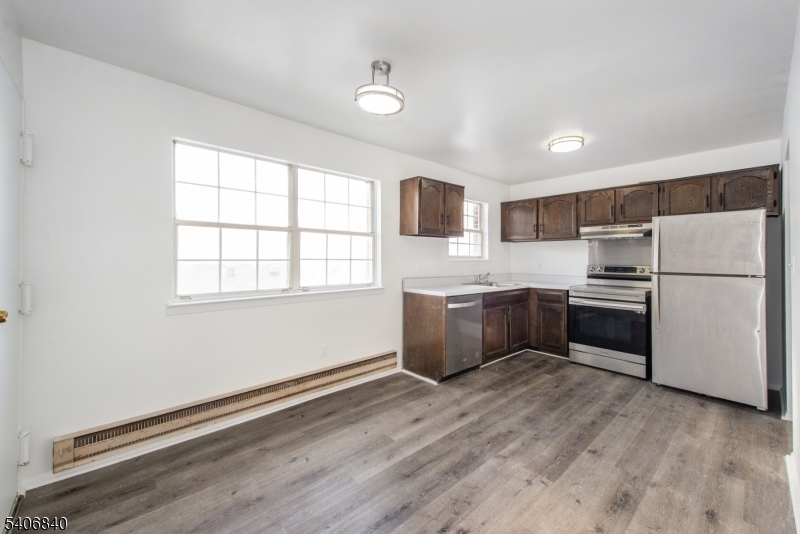 322 Richard Mine Road, Unit F5 Wharton, NJ 07885 - Photo 5 of 22 a kitchen with stainless steel appliances a refrigerator sink and cabinets