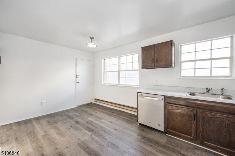 322 Richard Mine Road, Unit F5 Wharton, NJ 07885 - Photo 6 of 22 a kitchen with a sink wooden floor and window