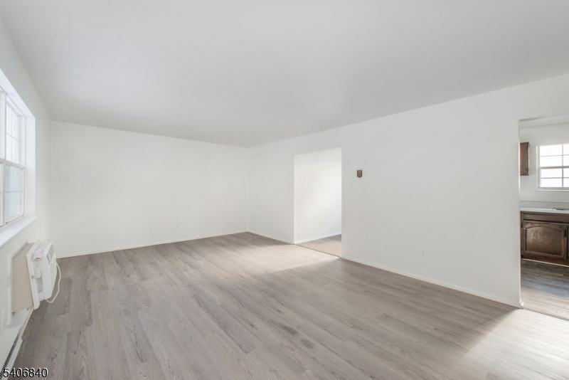 322 Richard Mine Road, Unit F5 Wharton, NJ 07885 - Photo 8 of 22 an empty room with wooden floor and a window