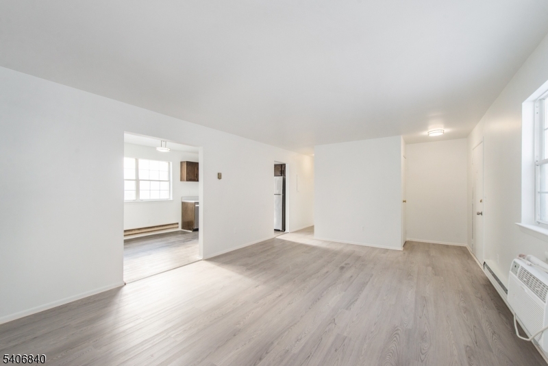 322 Richard Mine Road, Unit F5 Wharton, NJ 07885 - Photo 9 of 22 an empty room with wooden floor and windows
