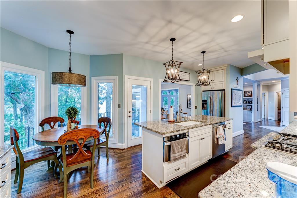4027 Windward Drive Tega Cay, SC 29708 - Photo 15 of 44 a view of a dining room with furniture window and wooden floor