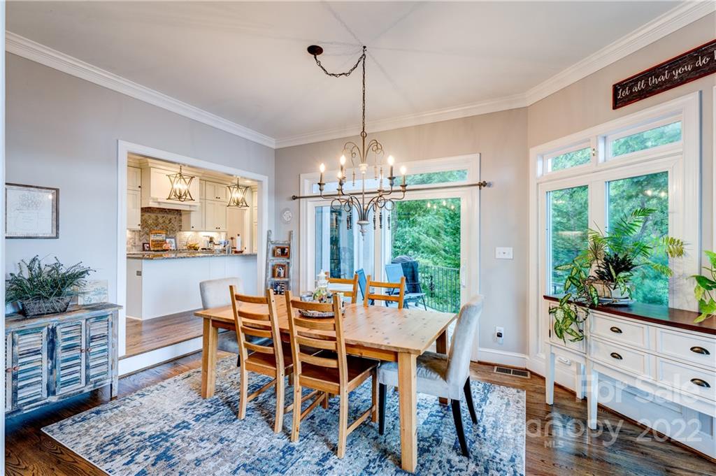4027 Windward Drive Tega Cay, SC 29708 - Photo 16 of 44 a dining room with furniture a chandelier and wooden floor