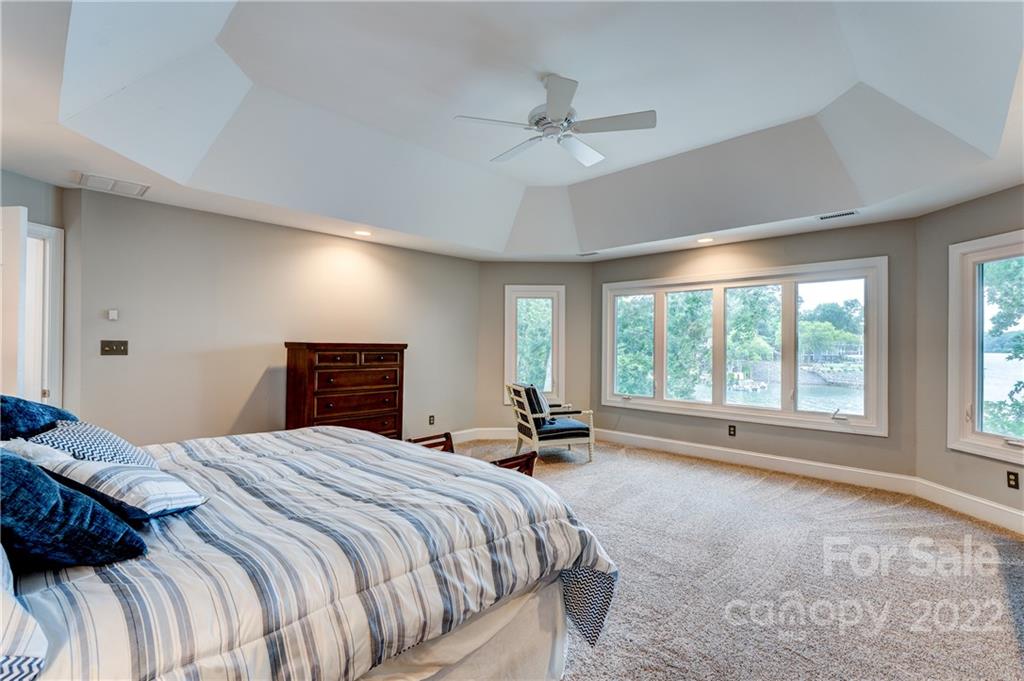 4027 Windward Drive Tega Cay, SC 29708 - Photo 23 of 44 a spacious bedroom with a bed and a large window