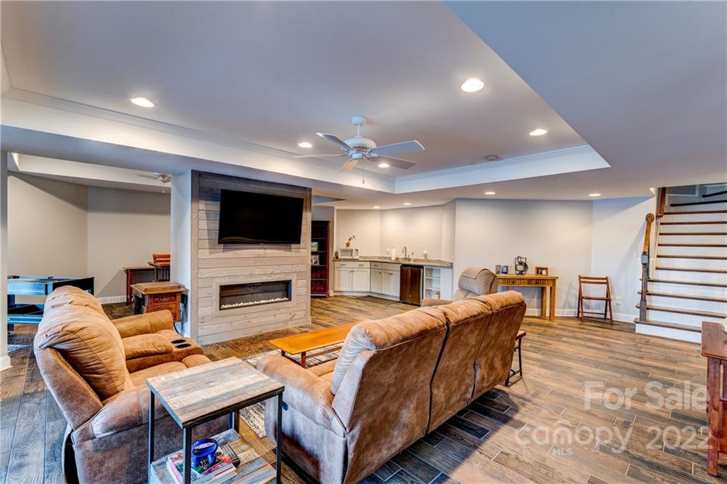 4027 Windward Drive Tega Cay, SC 29708 - Photo 35 of 44 a spacious bedroom with a bed and a flat screen tv