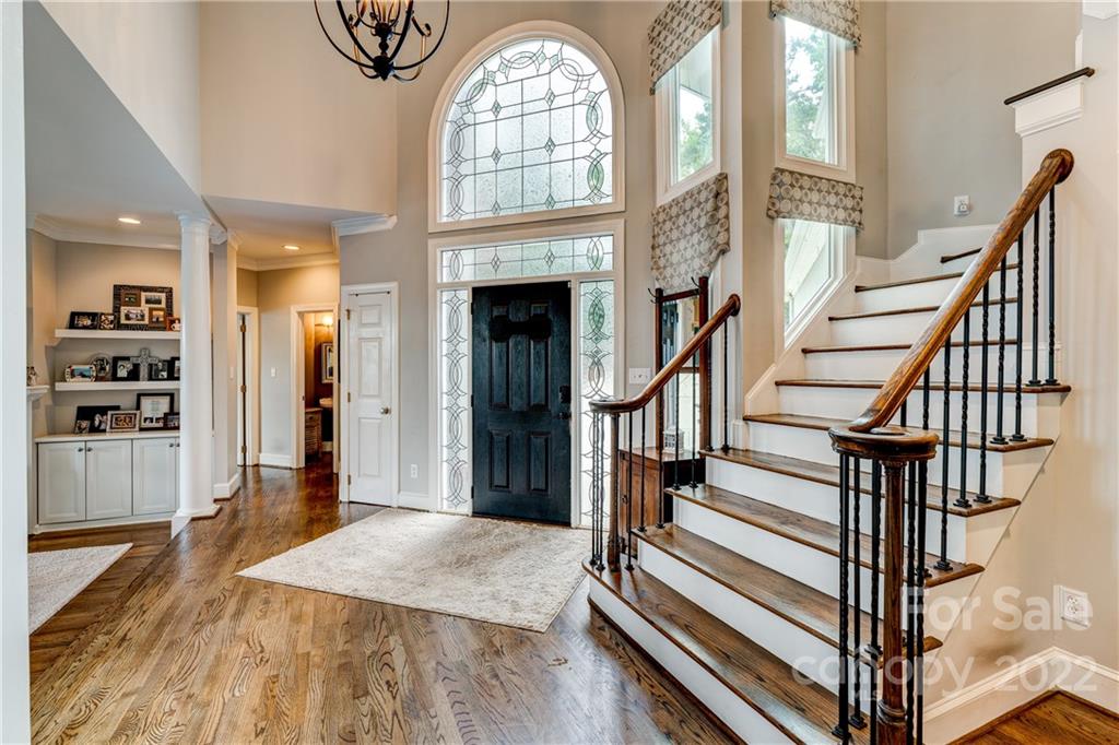 4027 Windward Drive Tega Cay, SC 29708 - Photo 9 of 44 a view of hall way with wooden floor and staircase