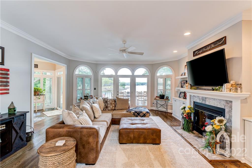 4027 Windward Drive Tega Cay, SC 29708 - Photo 10 of 44 a living room with fireplace furniture and a flat screen tv