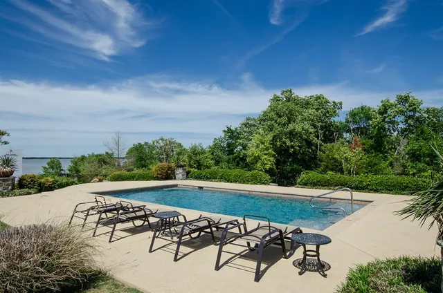 a view of a swimming pool with a yard
