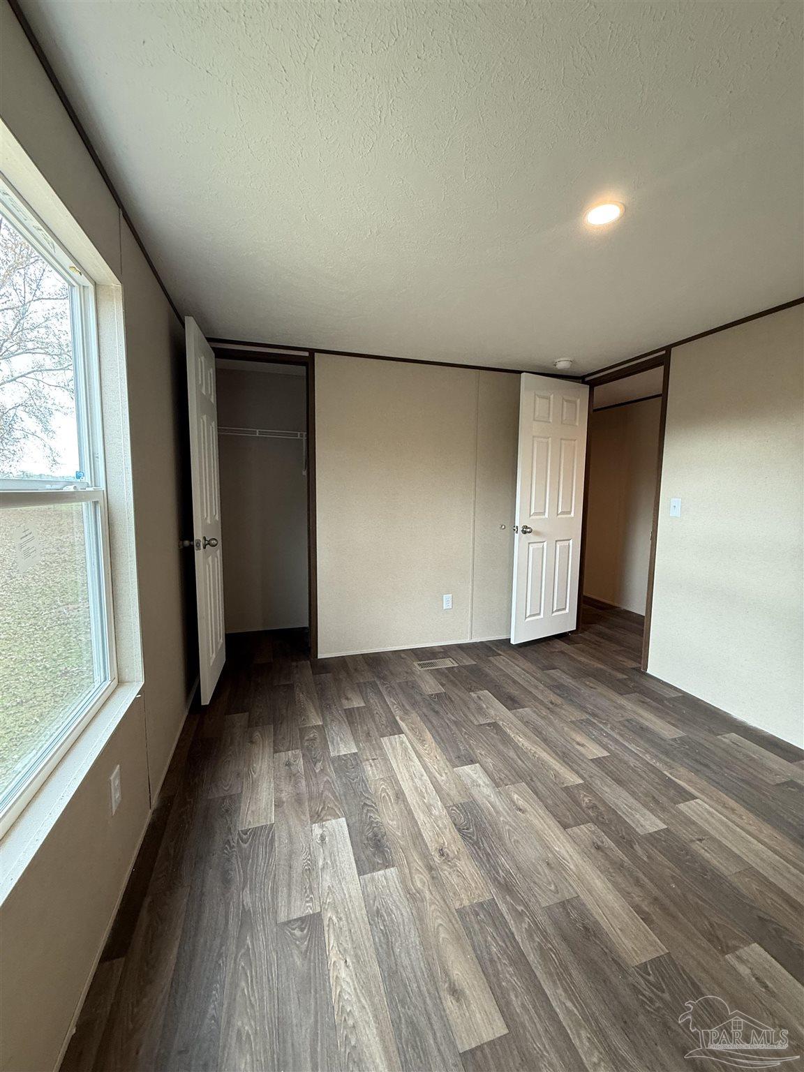 4468 Custer Lane Jay, FL 32565 - Photo 12 of 16 a view of empty room with wooden floor and fan