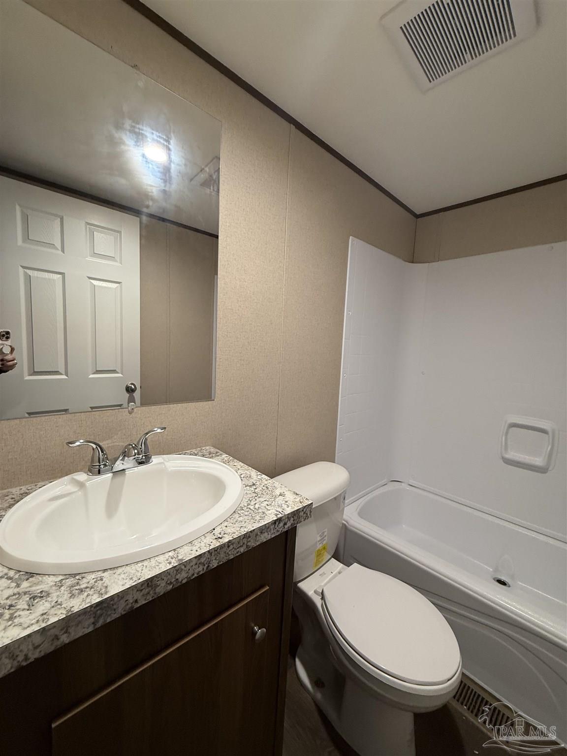 4468 Custer Lane Jay, FL 32565 - Photo 13 of 16 a bathroom with a granite countertop toilet sink and mirror