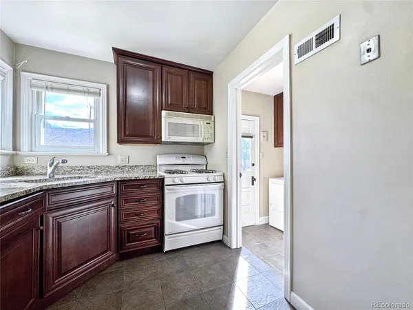 a spacious bathroom with a granite countertop sink and a mirror