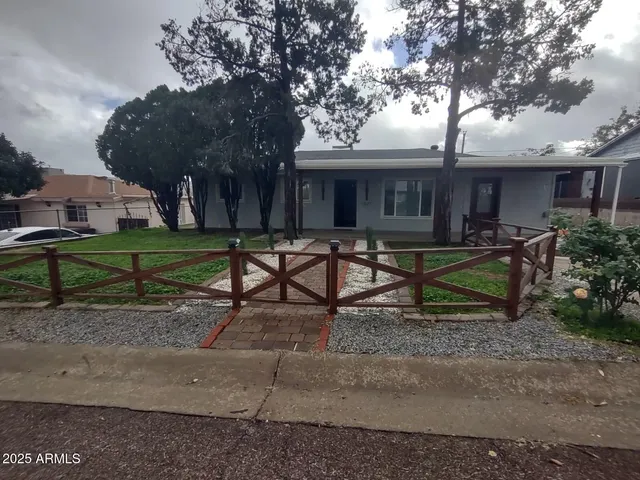 a house view with a sitting space and garden