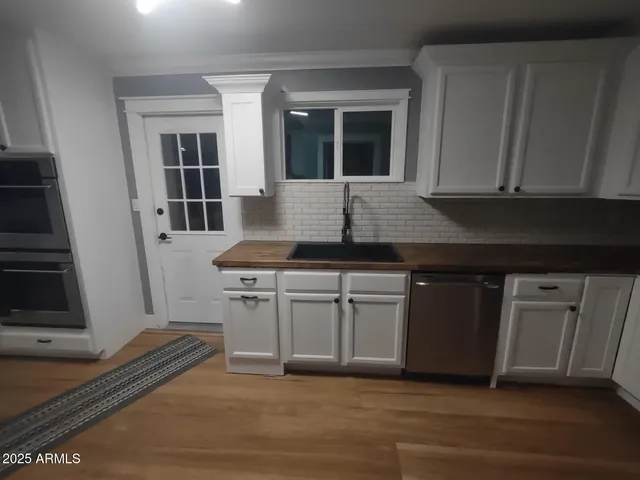 a kitchen with granite countertop a sink and a stove