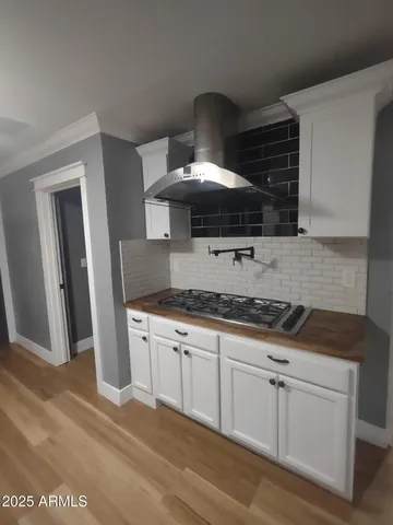 a kitchen with granite countertop a stove top oven cabinetry and granite counter tops