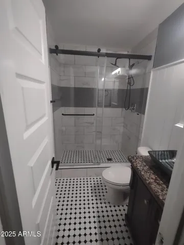 a bathroom with a sink toilet and shower