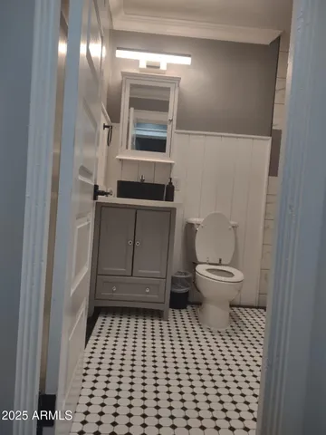 a bathroom with a sink a toilet and a mirror