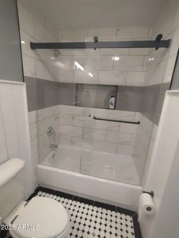 a bathroom with a toilet a sink and bathtub