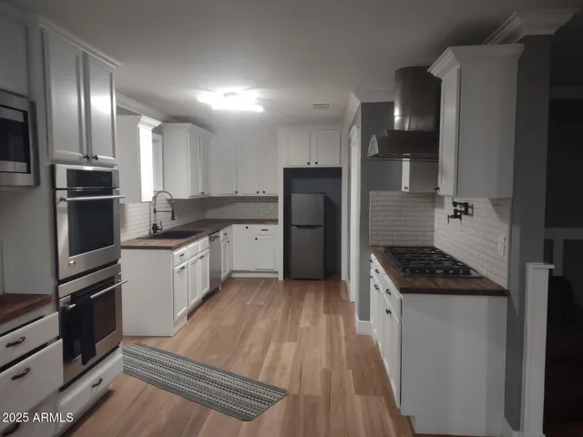 a kitchen with a refrigerator a sink and a stove