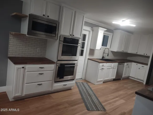 a kitchen with stainless steel appliances a stove microwave and cabinets