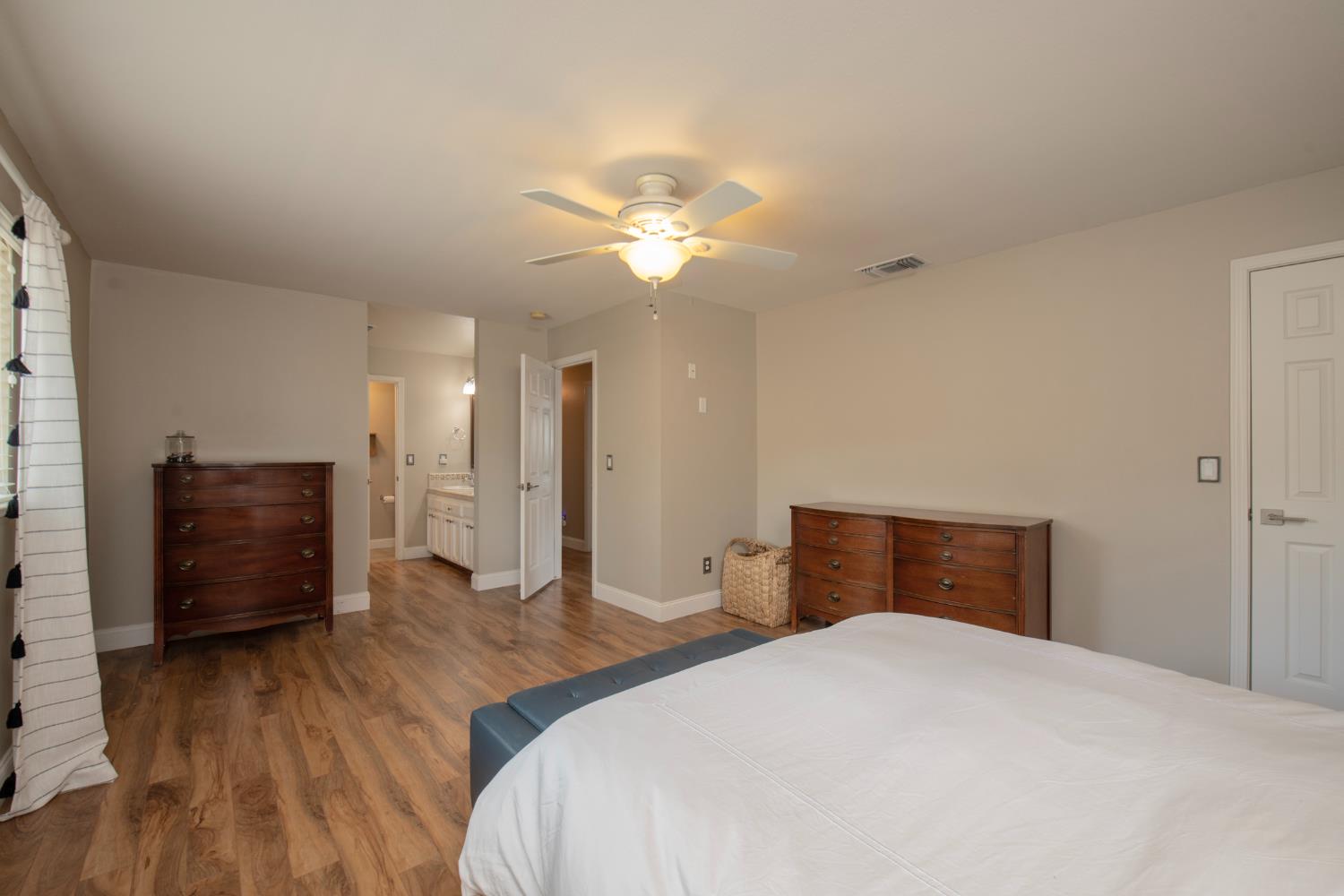 29395 Revis Road Coarsegold, CA 93614 - Photo 7 of 32 a bedroom with a bed and a chandelier