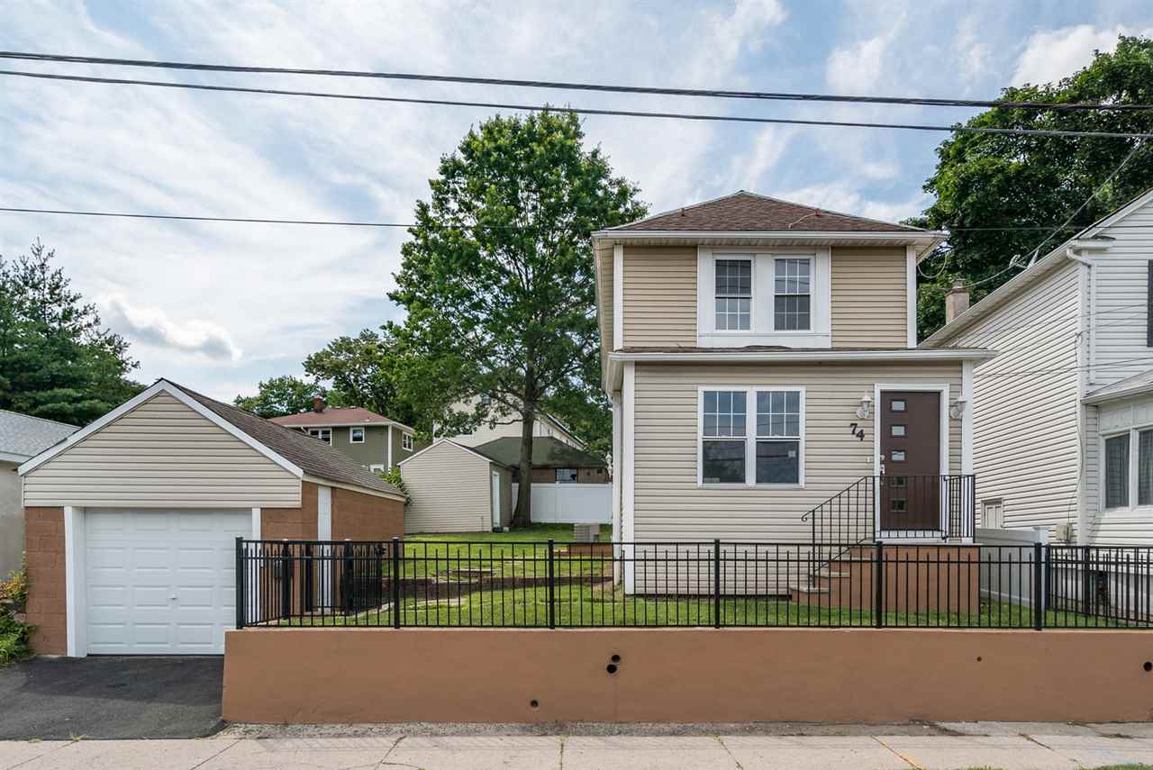 74 Meadow Road Rutherford, NJ 07070 - Photo 1 of 1 a front view of a house with a garden and plants