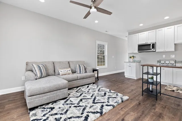 a living room with furniture and kitchen view