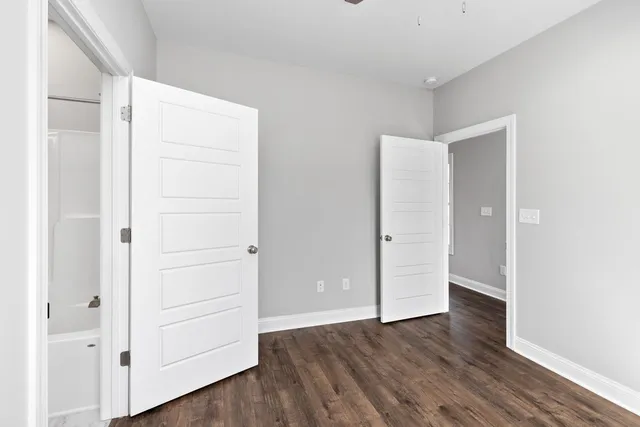 an empty room with wooden floor