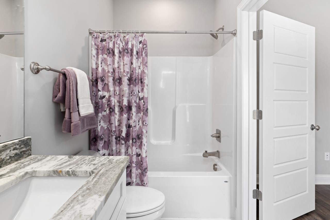 1013 B Street Waynesboro, VA 22980 - Photo 15 of 27 a bathroom with a granite countertop sink toilet and shower