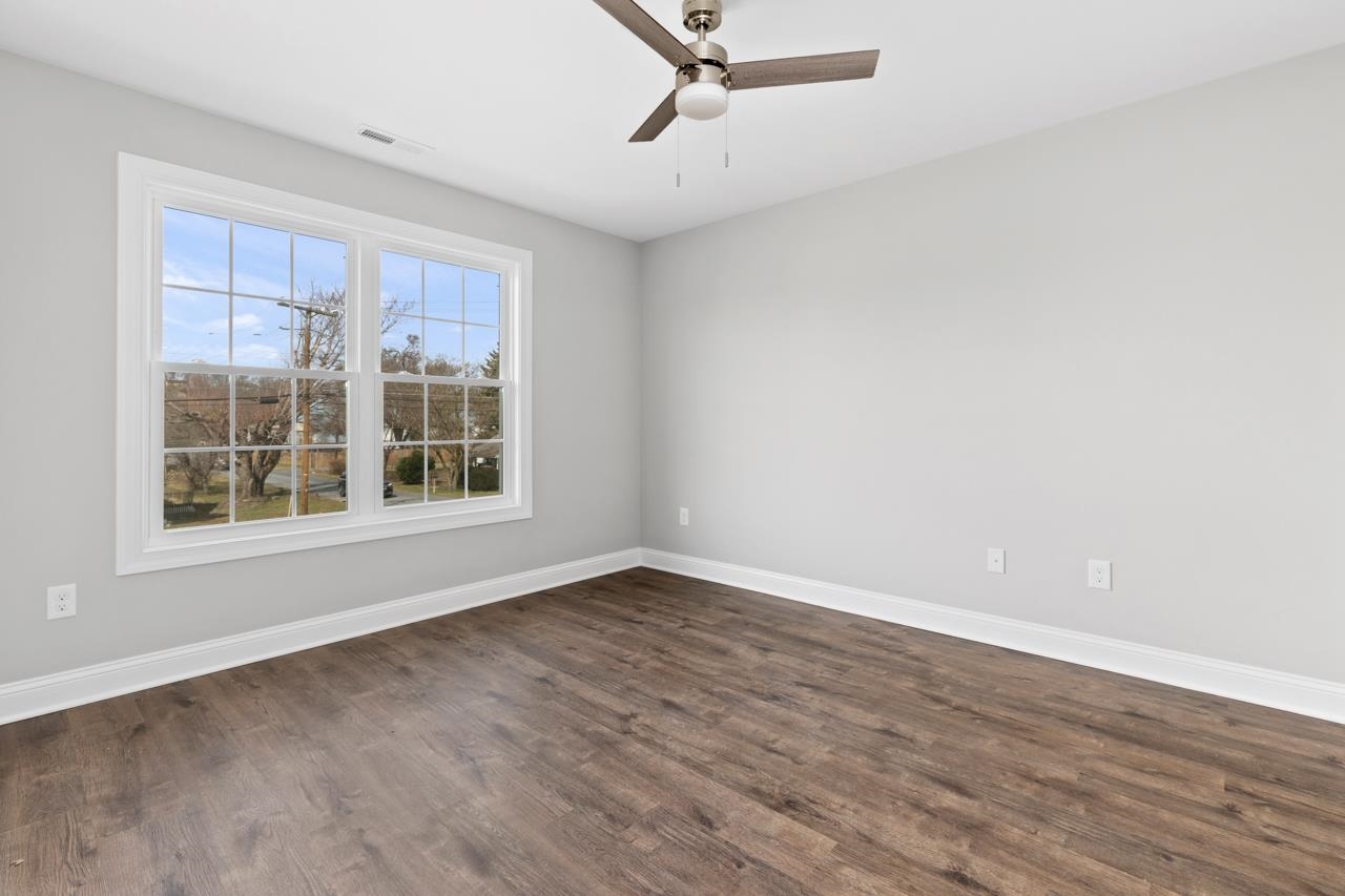 1013 B Street Waynesboro, VA 22980 - Photo 18 of 27 an empty room with wooden floor and windows