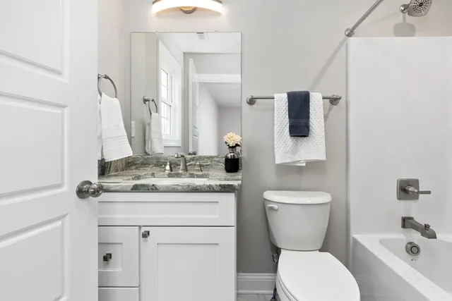 a bath tub sitting next to a white sink
