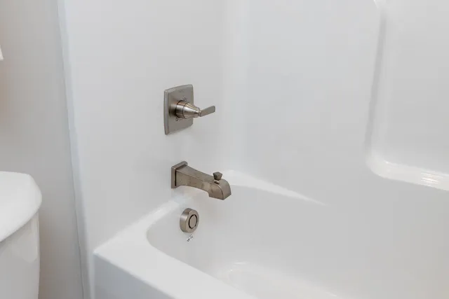 a bathroom with a granite countertop sink a mirror and vanity