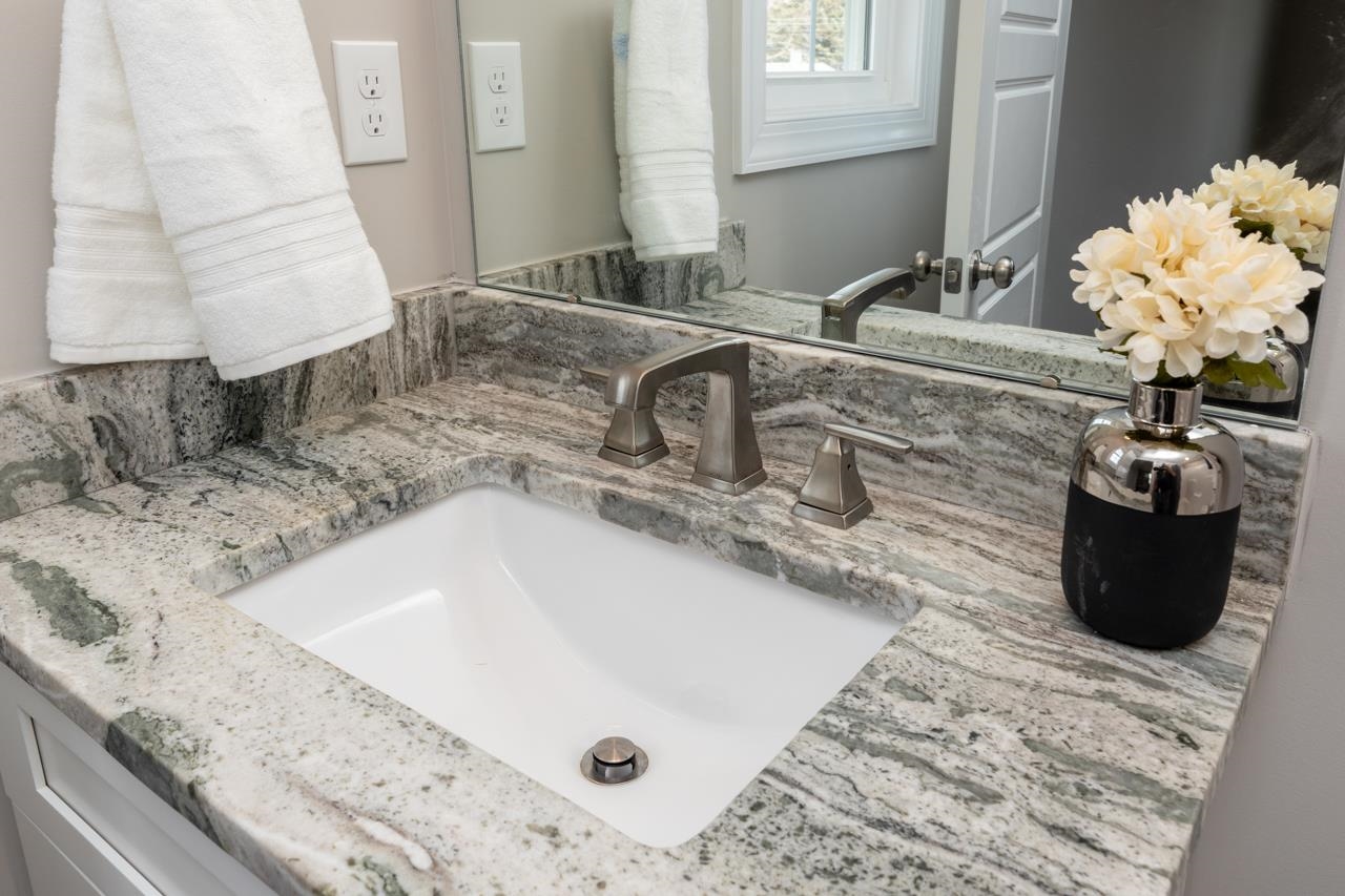 1013 B Street Waynesboro, VA 22980 - Photo 22 of 27 a bathroom with a granite countertop sink a mirror and vanity