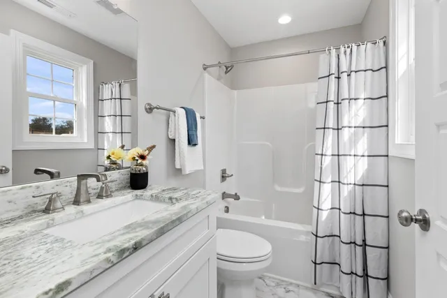 a view of a walk in closet with wooden floor