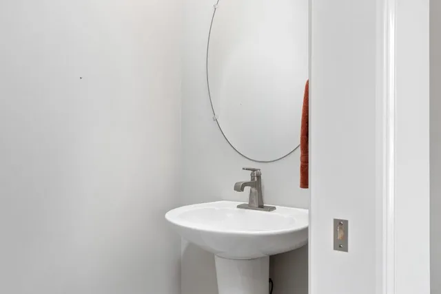 a bathroom with a sink a mirror and a window