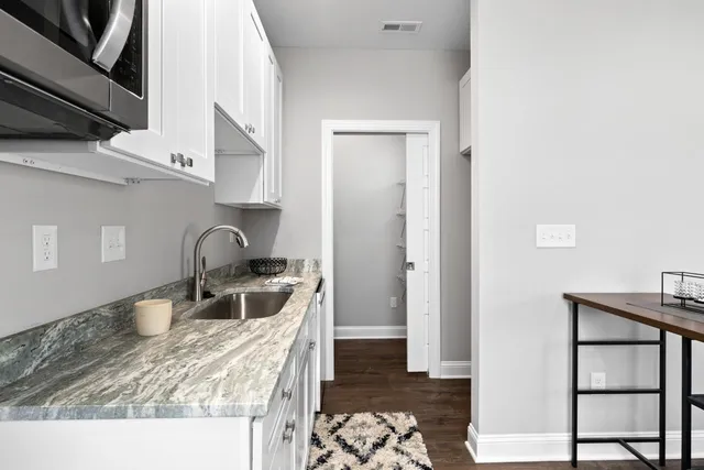 a kitchen with a wooden floor and a sink