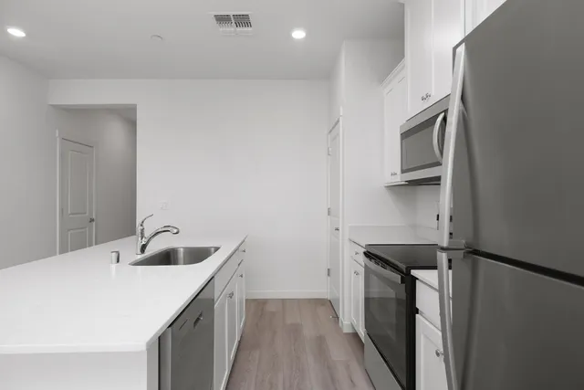 a kitchen with a sink and cabinets