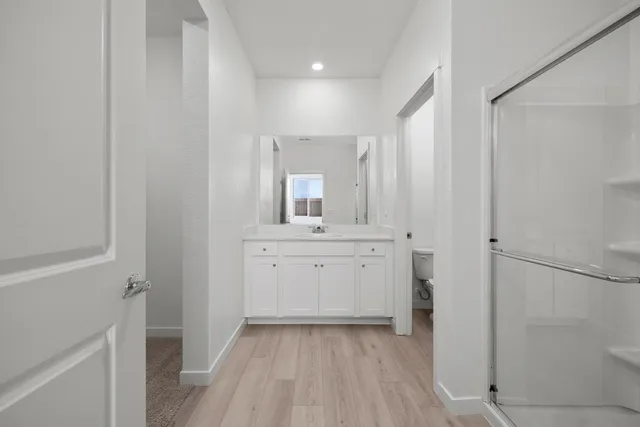a bathroom with a sink a mirror and a shower