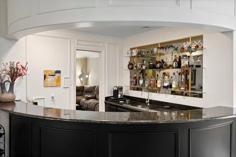 a kitchen with a sink and a mirror