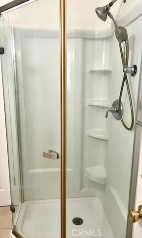 a bathroom with a glass shower door
