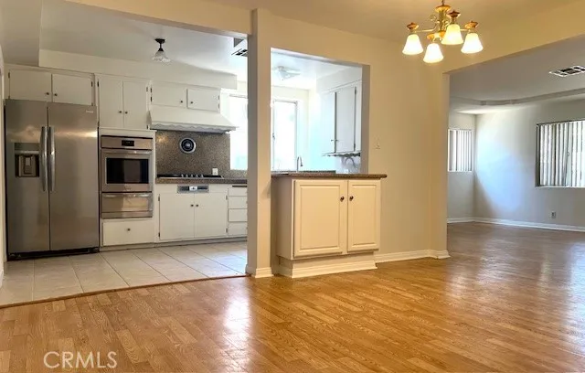a kitchen with stainless steel appliances a refrigerator sink and stove