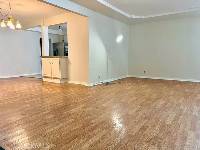 a view of wooden floor and cabinet in an empty room