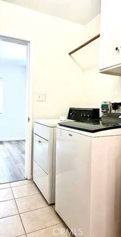 a kitchen with a sink and white cabinets