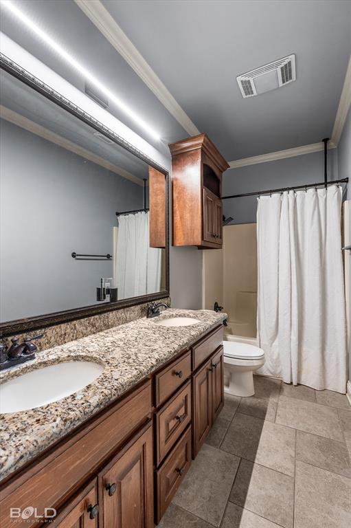2220 Forest Hills Boulevard Haughton, LA 71037 - Photo 33 of 40 Double vanity with light-toned granite countertop, under-mount sinks, and wood-finish cabinetry