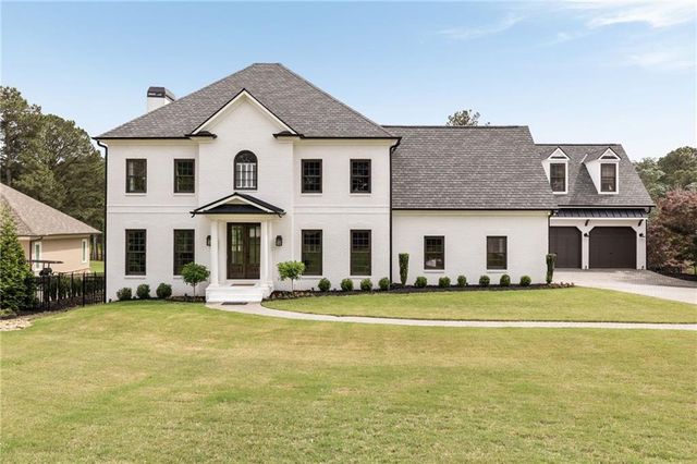 a view of a white house with a large windows